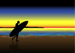 Surfer walking at sunset