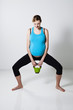 Pregnant woman exercising with kettlebell