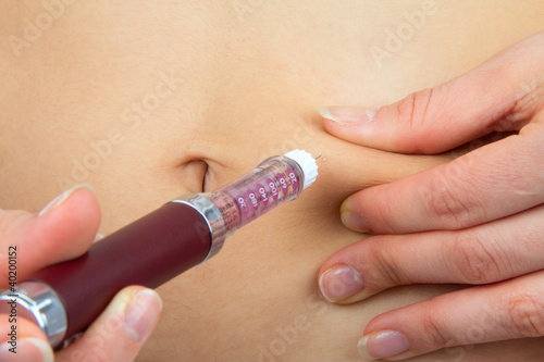 Photo: Diabetes patient make insulin injection shot by syringe in abdom Diabetes patient make insulin injection shot by syringe in abdom