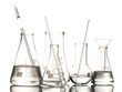 Different laboratory glassware with water and empty with