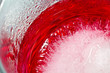 Red cream soda syrup in frozen glass from top close up