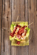Chicken skewers and crispy bacon