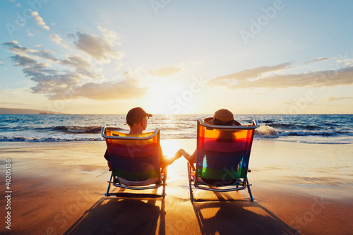 Photo: Happy Romantic Couple Enjoying Beautiful Sunset at the Beach Happy Romantic Couple Enjoying Beautiful Sunset at the Beach