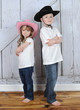 sibling cowboy and cowgirl in sweet pose