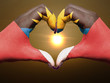 Heart and love gesture by hands colored in antigua barbuda flag