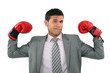 Businessman wearing boxing gloves