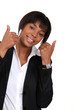 Businesswoman giving two thumbs-up