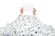 Person under crumpled pile of papers with a blank page / isolate