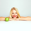 beautiful young blond smiling girl with green apple
