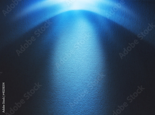 Photo: Blue light beam hitting at the rough surface with copy space Blue light beam hitting at the rough surface with copy space