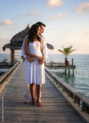 Photo: Sensual happy couple in white clothes on a pier (Maldives) Sensual happy couple in white clothes on a pier (Maldives)