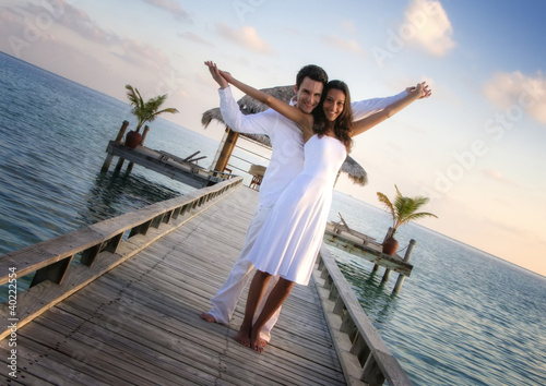 Photo: Sensual happy couple in white clothes on a pier (Maldives) Sensual happy couple in white clothes on a pier (Maldives)