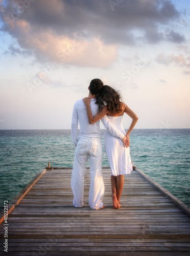 Photo: Sensual happy couple in white clothes on a pier (Maldives) Sensual happy couple in white clothes on a pier (Maldives)