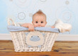 handsome baby boy peeking out of wicker basket