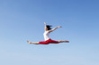 Asian woman jumping over blue sky