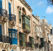 Baroque Facades And Traditional Balconies In Valletta Street