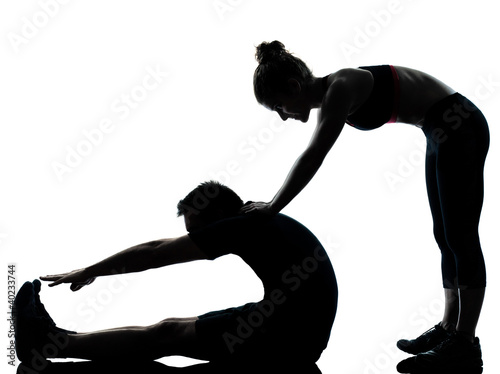 Photo: one couple man woman exercising workout fitness one couple man woman exercising workout fitness