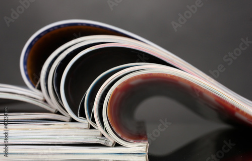 Photo: open magazines on gray background open magazines on gray background