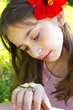 Young girl perched on his hand looking dragonfly