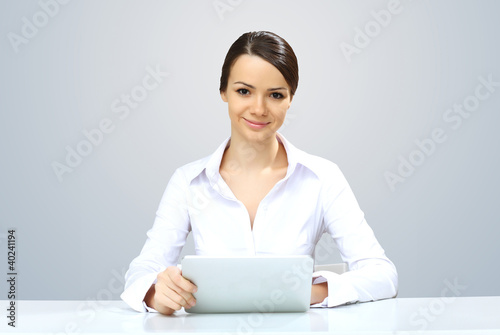 Photo: Young beautiful woman in business wear at work Young beautiful woman in business wear at work