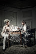 Young couple drinking coffee in an old castle