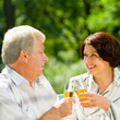 Senior couple celebrating with champagne, outdoors Senior couple celebrating with champagne, outdoors