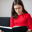 Girl reading book at home Girl reading book at home