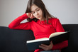 Girl reading book at home Girl reading book at home