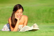 Woman reading book in park