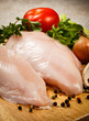 Raw chicken breasts on cutting board