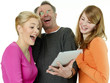 Foto: Father and his daughters having fun by surfing on the internet Father and his daughters having fun by surfing on the internet