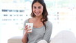 A woman relaxes with a cup of coffee