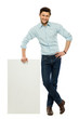 Businessman holding blank poster