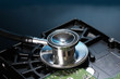 Stethoscope on hard disk drive on dark blue background Stethoscope on hard disk drive on dark blue background