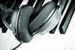 headphones on piano keyboards