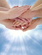 A lot of hands for keeping together in front of blue sky