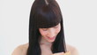 Smiling woman combing her hair
