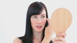 Smiling woman brushing her fringe