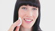Happy woman using a cotton wool