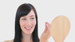 Smiling woman plucking her eyebrow