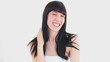 Happy brunette woman touching her hair