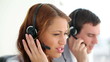 Happy call centre agents talking on their headsets