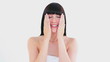 Cheerful woman rubbing her cheeks