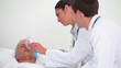 Doctors placing an oxygen mask on a patient