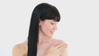 Peaceful brunette woman massaging her shoulder