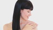 Smiling brunette woman massaging her shoulder