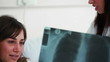 Happy patient looking at her X-ray scan
