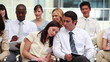 Woman sleeping on her colleagues shoulder 