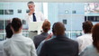 Man with grey hair behind a lectern 