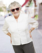 portrait of senior woman standing wearing sunglasses at city portrait of senior woman standing wearing sunglasses at city